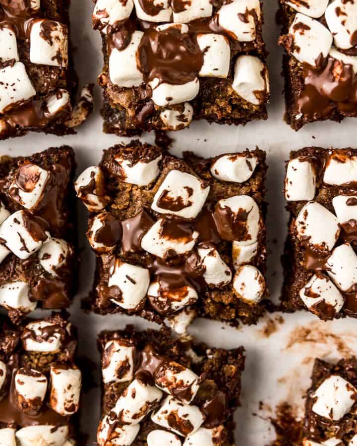 Close up of a vegan and oil-free s'mores cookie bar with melted chocolate and mini vegan marshmallows.
