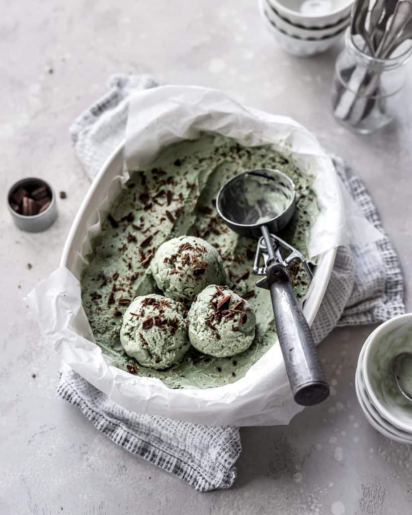 Healthy No-Churn Vegan Mint Chocolate Chip Ice Cream scooped in a casserole dish.